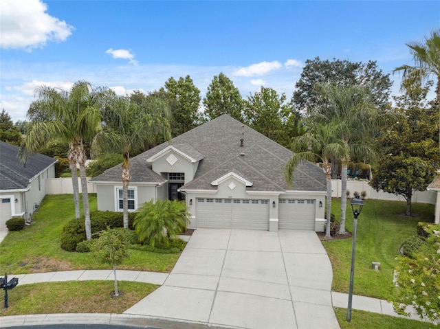 3243 Stonegate Falls Dr, Land O Lakes, FL 34638 - view of front of property featuring an attached garage, stucco siding, concrete driveway, and a shingled roof