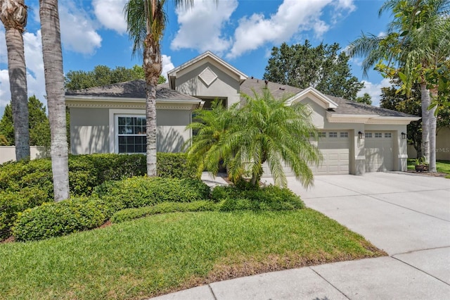 3243 Stonegate Falls Dr, Land O Lakes, FL 34638 - ranch-style house featuring stucco siding, driveway, and a garage