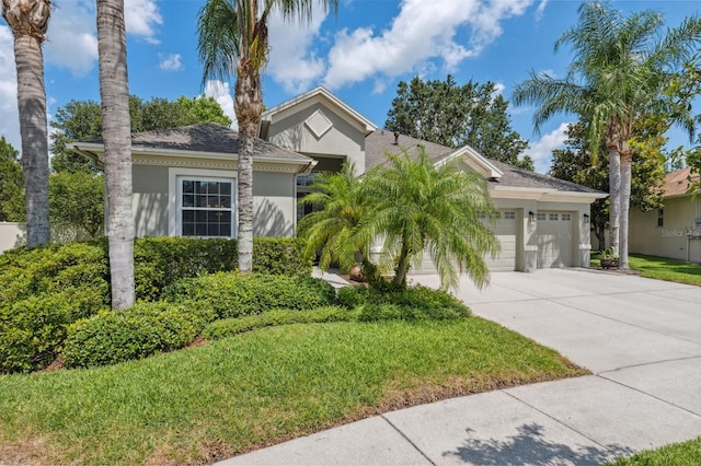 3243 Stonegate Falls Dr, Land O Lakes, FL 34638 - ranch-style house with stucco siding, an attached garage, driveway, and a front yard