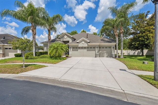 3243 Stonegate Falls Dr, Land O Lakes, FL 34638 - view of front of property with concrete driveway, an attached garage, and stucco siding