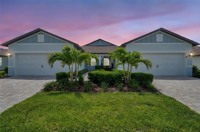 8431 Ocean Tides Cv, Parrish, FL 34219 - single story home featuring decorative driveway, board and batten siding, an attached garage, and a yard