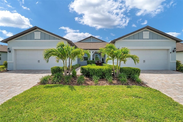 8431 Ocean Tides Cv, Parrish, FL 34219 - ranch-style home featuring decorative driveway, a garage, board and batten siding, and a front yard