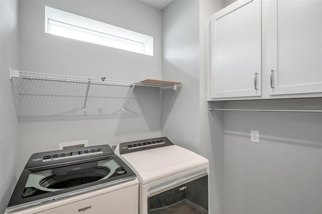 8431 Ocean Tides Cv, Parrish, FL 34219 - laundry area featuring cabinet space and washing machine and clothes dryer