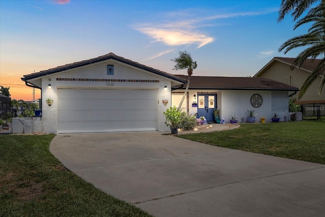 5340 Pilots Pl, New Port Richey, FL 34652 - single story home with driveway, a yard, a garage, a tile roof, and stucco siding