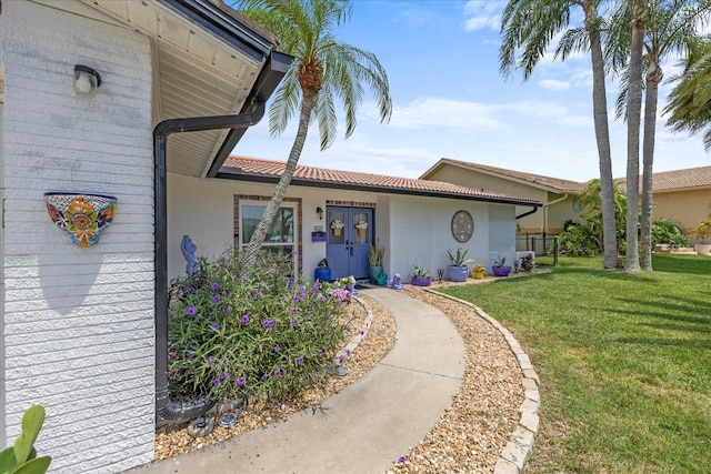 5340 Pilots Pl, New Port Richey, FL 34652 - view of front of home with a front lawn, a tile roof, and stucco siding