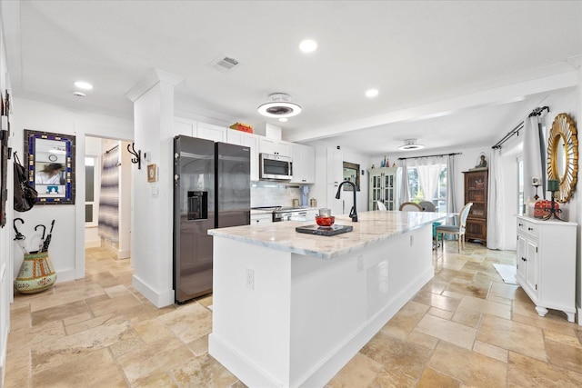 5340 Pilots Pl, New Port Richey, FL 34652 - kitchen featuring appliances with stainless steel finishes, stone tile flooring, white cabinets, and recessed lighting