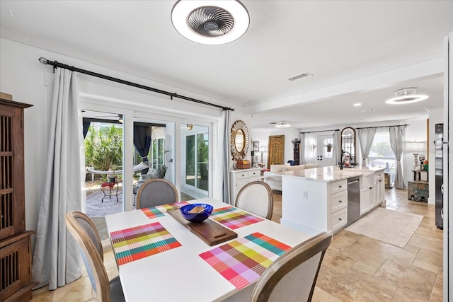 5340 Pilots Pl, New Port Richey, FL 34652 - dining space featuring healthy amount of natural light and light stone finish flooring
