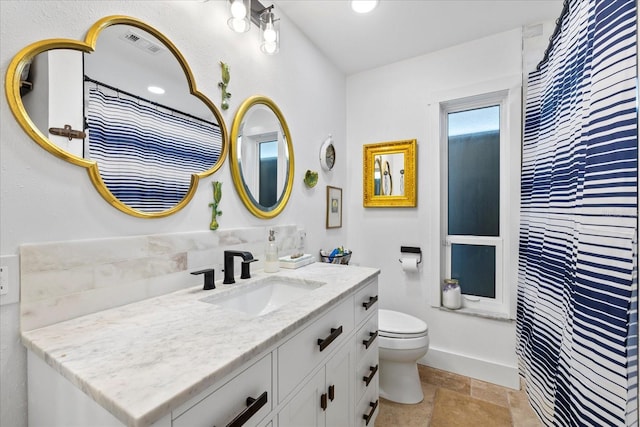 5340 Pilots Pl, New Port Richey, FL 34652 - bathroom with vanity, toilet, stone finish floors, and baseboards