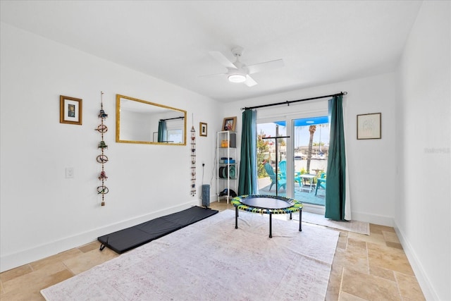 5340 Pilots Pl, New Port Richey, FL 34652 - sitting room featuring stone finish flooring, a ceiling fan, and baseboards