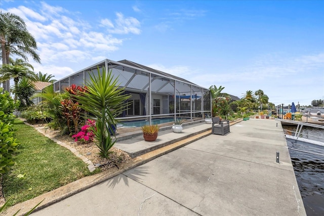 5340 Pilots Pl, New Port Richey, FL 34652 - rear view of property with an outdoor pool, a patio, and glass enclosure