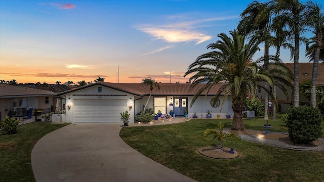 5340 Pilots Pl, New Port Richey, FL 34652 - single story home with stucco siding, an attached garage, a tile roof, and a front lawn