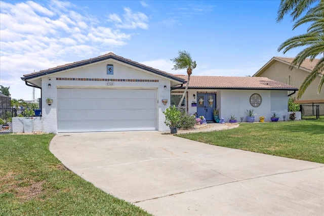 5340 Pilots Pl, New Port Richey, FL 34652 - single story home with a front lawn, driveway, an attached garage, a tile roof, and stucco siding