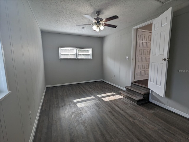 2004 Culberson Ave, Dunedin, FL 34698 - unfurnished bedroom with dark wood-type flooring, a textured ceiling, baseboards, and ceiling fan