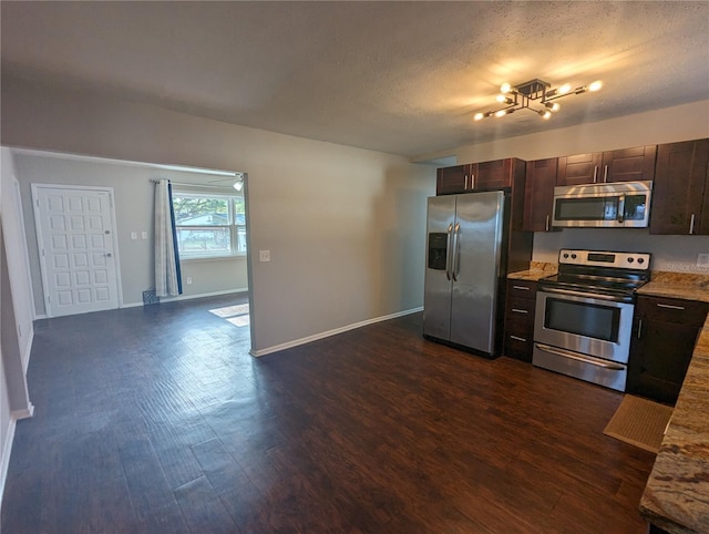 2004 Culberson Ave, Dunedin, FL 34698 - kitchen featuring stainless steel appliances, dark wood-type flooring, dark brown cabinets, baseboards, and a textured ceiling