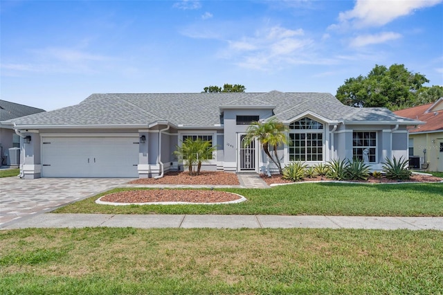 ranch-style home featuring a garage, a front lawn, and stucco siding