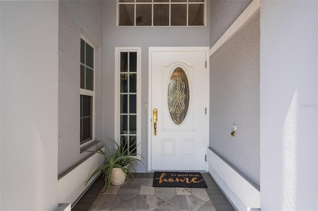 property entrance featuring stucco siding