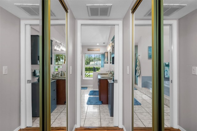 corridor with light tile patterned floors