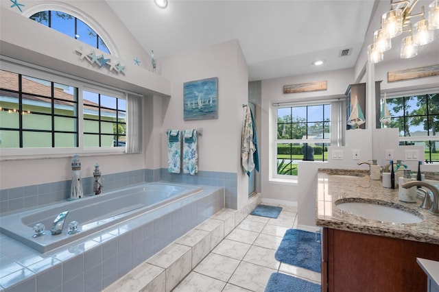 full bath featuring a bath, a shower stall, tile patterned floors, double vanity, and vaulted ceiling