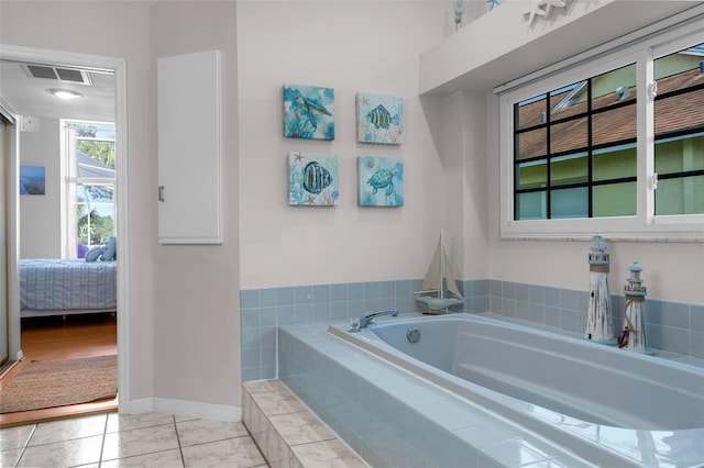full bathroom with ensuite bathroom, baseboards, and a garden tub
