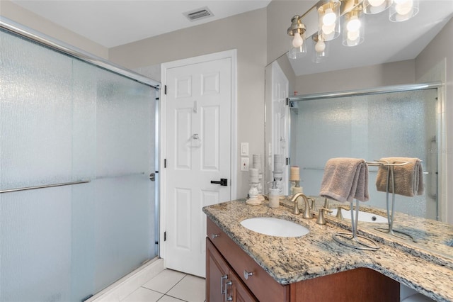 full bathroom featuring a shower stall, vanity, tile patterned floors, and a chandelier