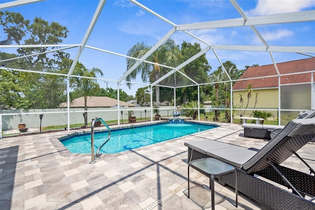 view of swimming pool with a patio area and a lanai