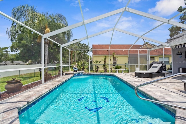 swimming pool featuring a patio and glass enclosure