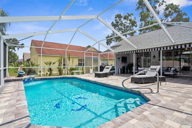 outdoor pool featuring outdoor lounge area, a patio area, and a lanai