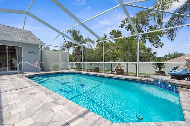 view of pool with a patio area and glass enclosure