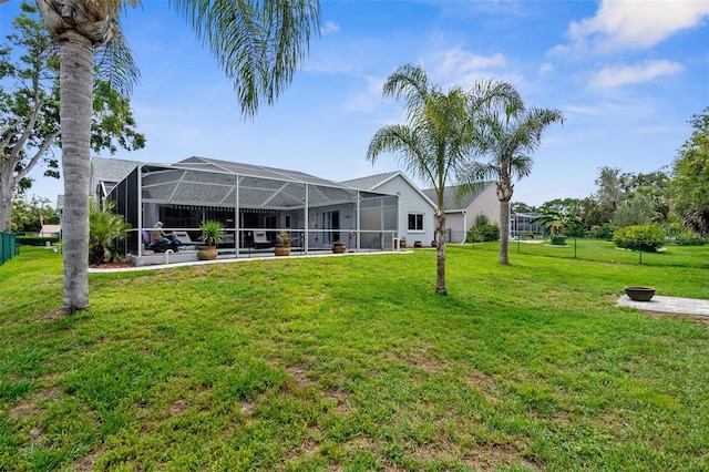 rear view of house featuring a yard and a lanai