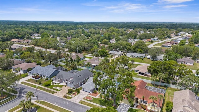 aerial view of property and surrounding area featuring nearby suburban area