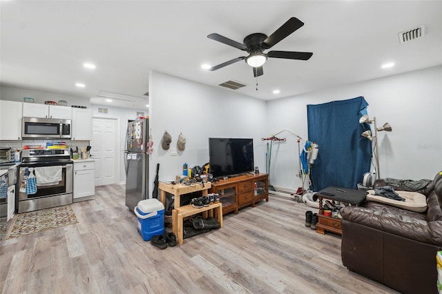 4737 6th St, Zephyrhills, FL 33542 - living room featuring light wood-style floors, a ceiling fan, and recessed lighting