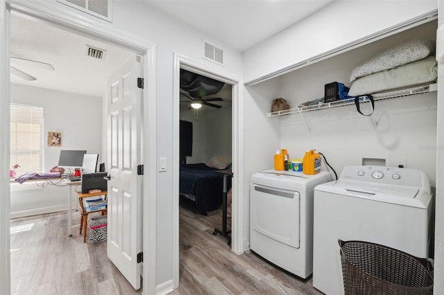 4737 6th St, Zephyrhills, FL 33542 - laundry room with a ceiling fan, separate washer and dryer, light wood finished floors, and baseboards
