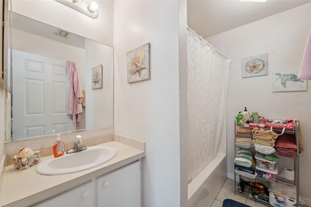 4737 6th St, Zephyrhills, FL 33542 - bathroom featuring vanity, tile patterned floors, a textured ceiling, and shower / tub combo