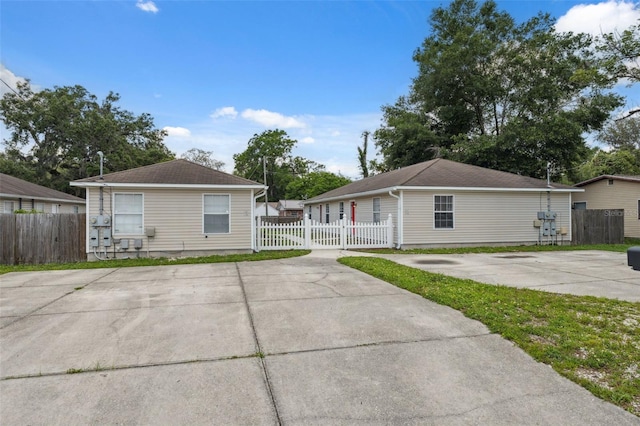 4737 6th St, Zephyrhills, FL 33542 - view of front of home with a fenced front yard and roof with shingles