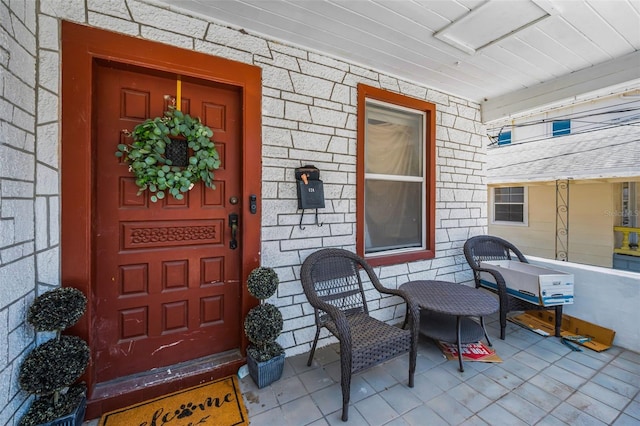124 Athens St, Tarpon Springs, FL 34689 - property entrance with a porch and stone siding