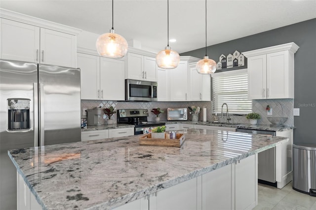 5328 Baldock Ave, Spring Hill, FL 34608 - kitchen featuring appliances with stainless steel finishes, white cabinets, a center island, decorative backsplash, and recessed lighting