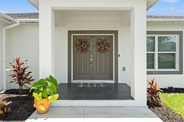 5328 Baldock Ave, Spring Hill, FL 34608 - view of exterior entry featuring a shingled roof and stucco siding