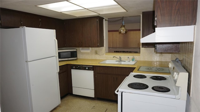5636 Dolores Dr, Holiday, FL 34690 - kitchen featuring white appliances, a sink, light countertops, and decorative backsplash