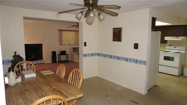 5636 Dolores Dr, Holiday, FL 34690 - dining space with a ceiling fan, light colored carpet, and baseboard heating