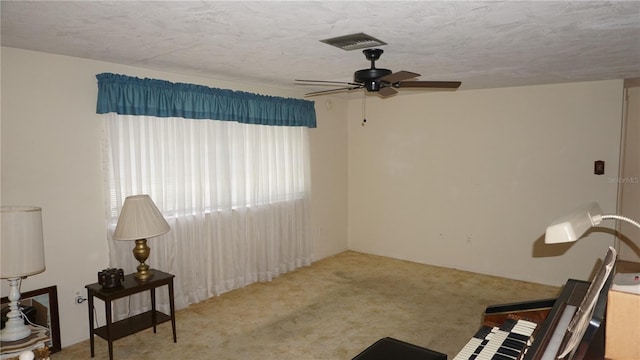 5636 Dolores Dr, Holiday, FL 34690 - living area featuring ceiling fan, carpet floors, and a textured ceiling