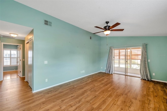9212 Estrada Pl, New Port Richey, FL 34655 - unfurnished room with ceiling fan, baseboards, wood finished floors, and lofted ceiling