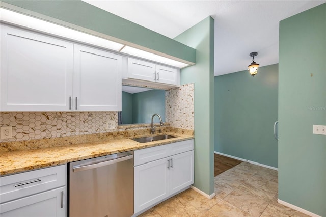 9212 Estrada Pl, New Port Richey, FL 34655 - kitchen with dishwasher, a sink, white cabinets, and backsplash