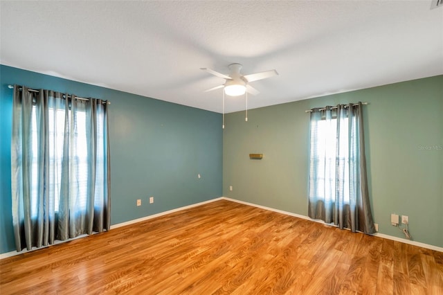 9212 Estrada Pl, New Port Richey, FL 34655 - empty room with a ceiling fan, wood finished floors, and baseboards