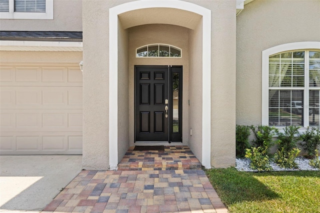 12055 Colony Lakes Blvd, New Port Richey, FL 34654 - entrance to property featuring stucco siding and a garage