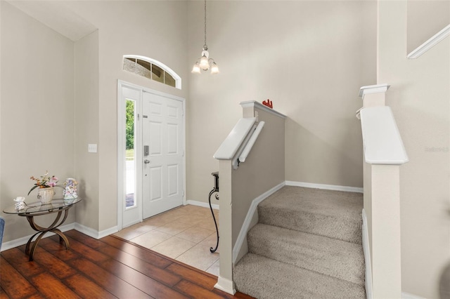 12055 Colony Lakes Blvd, New Port Richey, FL 34654 - entrance foyer with hardwood / wood-style flooring, baseboards, a high ceiling, and stairway