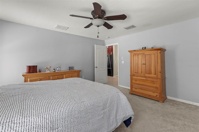 12055 Colony Lakes Blvd, New Port Richey, FL 34654 - bedroom featuring freestanding refrigerator, light colored carpet, baseboards, and ceiling fan
