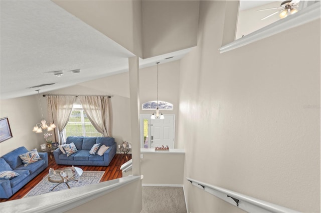 12055 Colony Lakes Blvd, New Port Richey, FL 34654 - living area featuring a chandelier, vaulted ceiling, a ceiling fan, wood finished floors, and baseboards