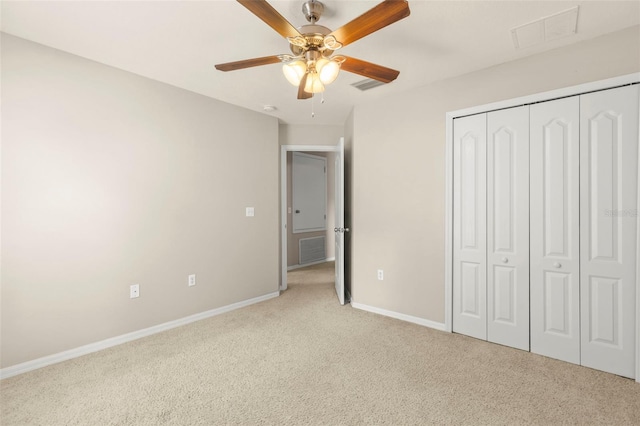 12055 Colony Lakes Blvd, New Port Richey, FL 34654 - unfurnished bedroom featuring baseboards, light carpet, a closet, and ceiling fan