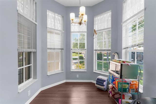 9407 Burnam Dr, Weeki Wachee, FL 34613 - playroom with a chandelier, healthy amount of natural light, wood finished floors, and baseboards