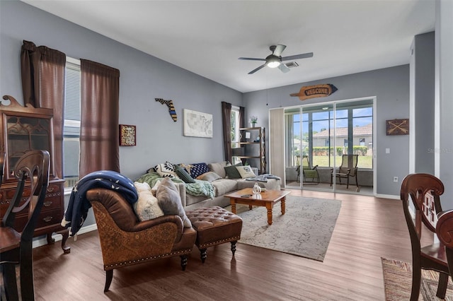 9407 Burnam Dr, Weeki Wachee, FL 34613 - living room featuring ceiling fan, wood finished floors, and baseboards